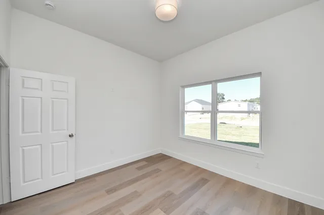 an empty room with wooden floor