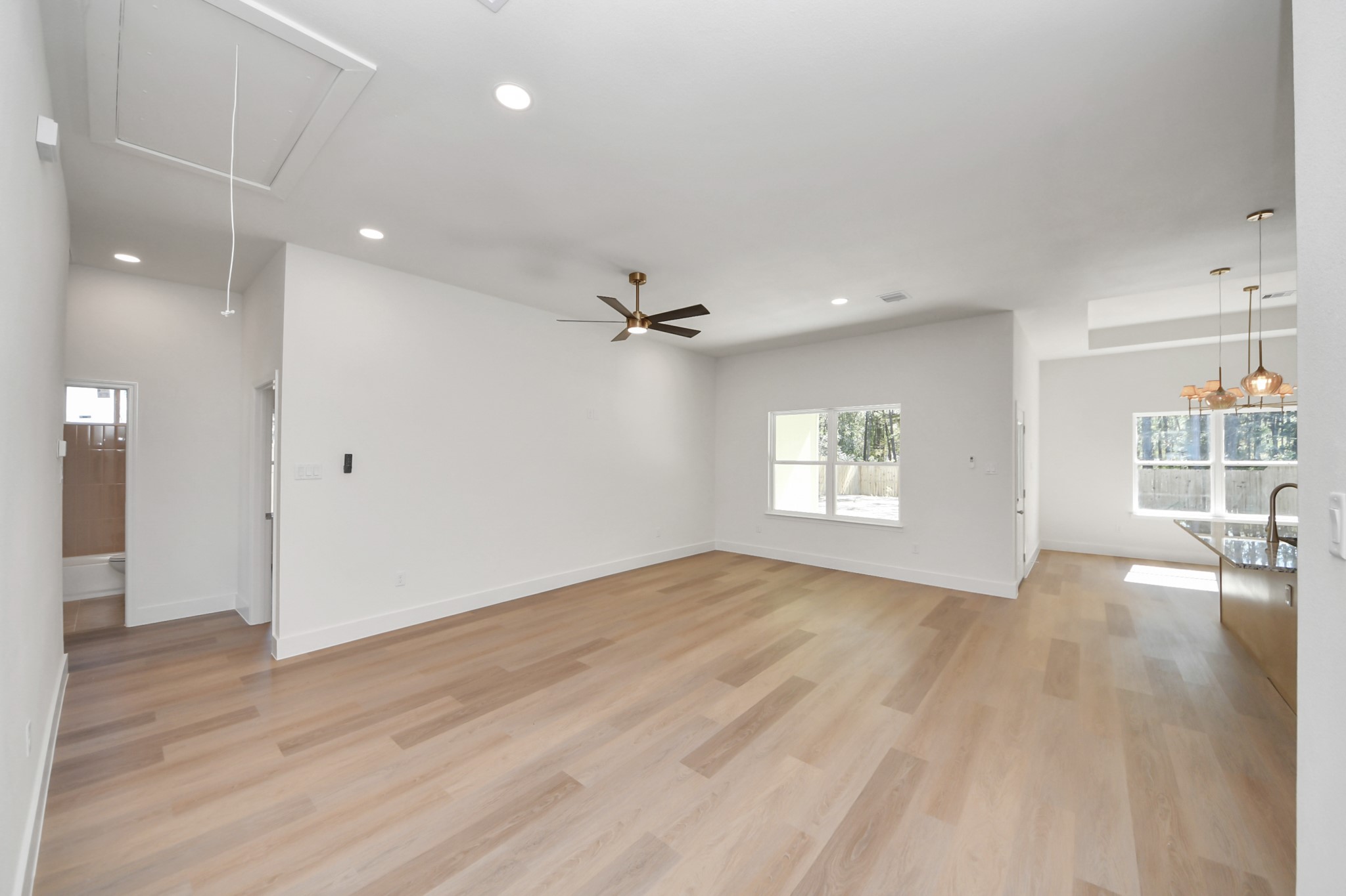16280 Jeet Street Conroe, TX 77306 - Photo 5 of 44 an empty room with wooden floor and windows