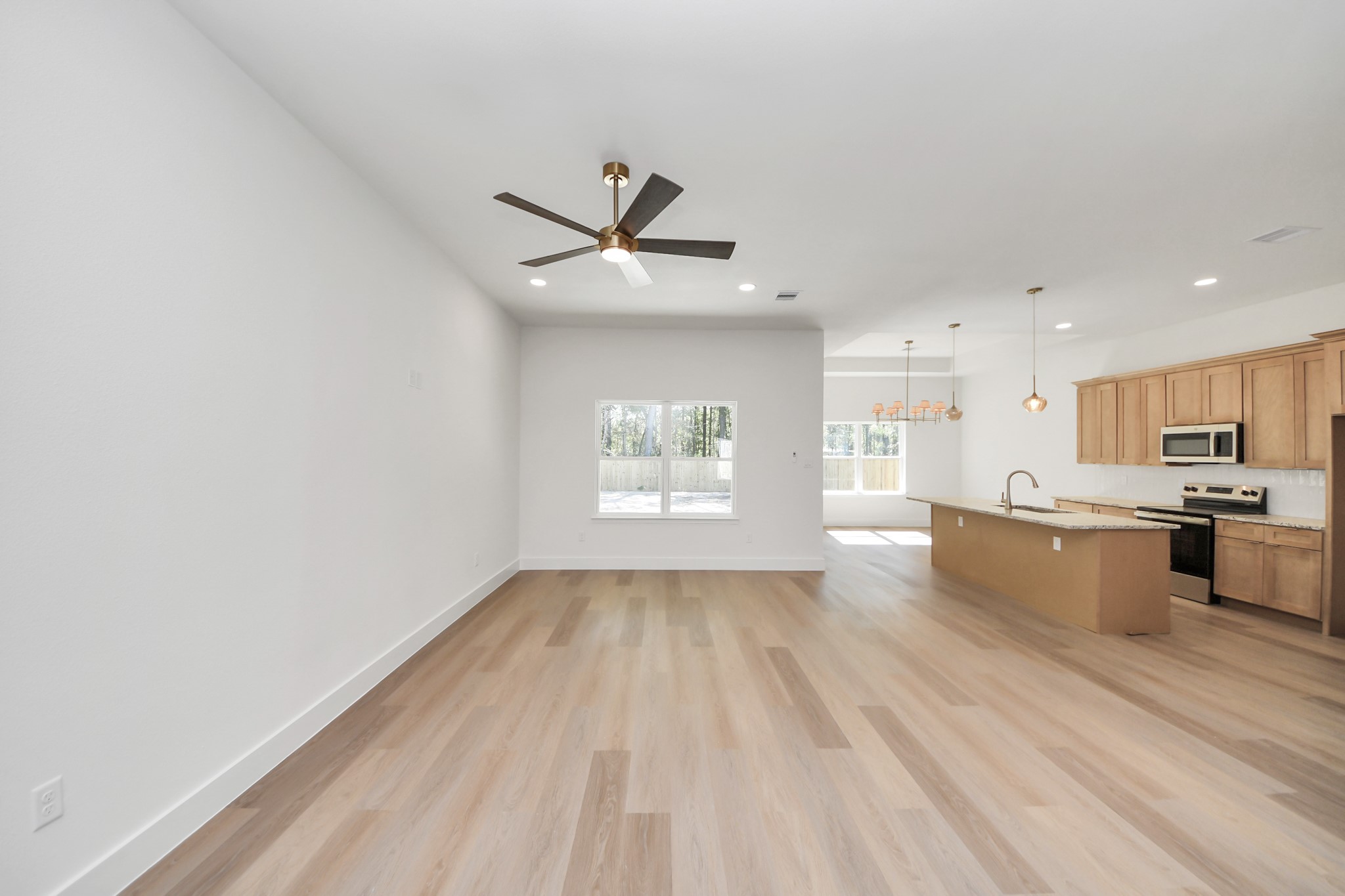 16280 Jeet Street Conroe, TX 77306 - Photo 6 of 44 a view of kitchen with refrigerator and window