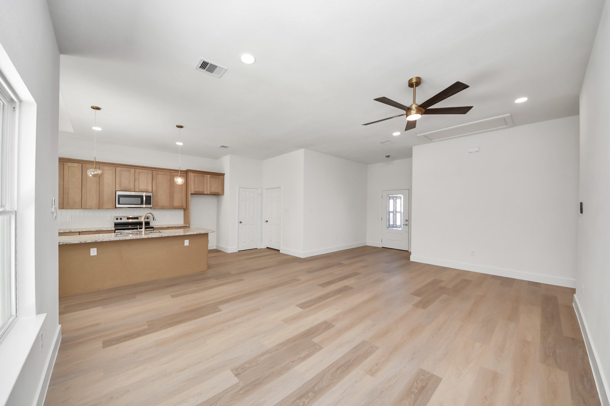 16280 Jeet Street Conroe, TX 77306 - Photo 10 of 44 a view of a kitchen with kitchen island a sink stainless steel appliances and cabinets