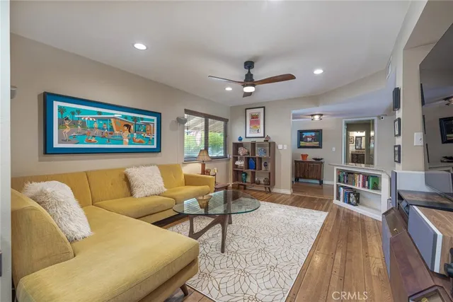 a living room with furniture and a wooden floor