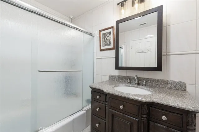 a bathroom with a granite countertop sink mirror and a