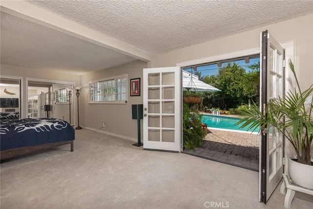 a view of a bedroom with furniture and floor to ceiling window
