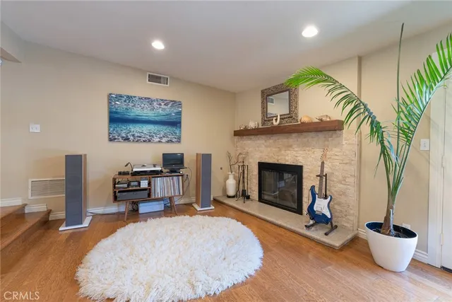 a living room with furniture a fireplace and a potted plant