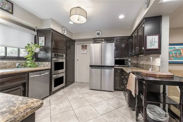 a kitchen with refrigerator cabinets and furniture
