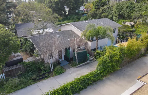 an aerial view of a house with a yard and a garage
