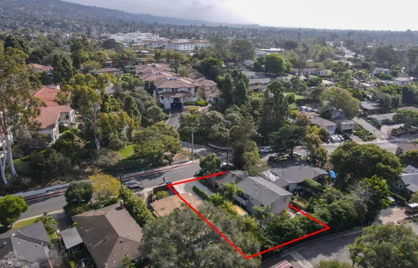 an aerial view of multiple houses with yard