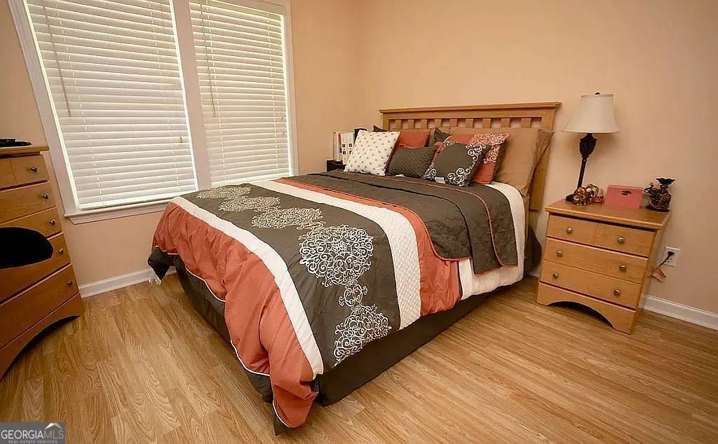 108 Christine Circle Perry, GA 31069 - Photo 16 of 23 a bed sitting in a bedroom next to a window with dresser