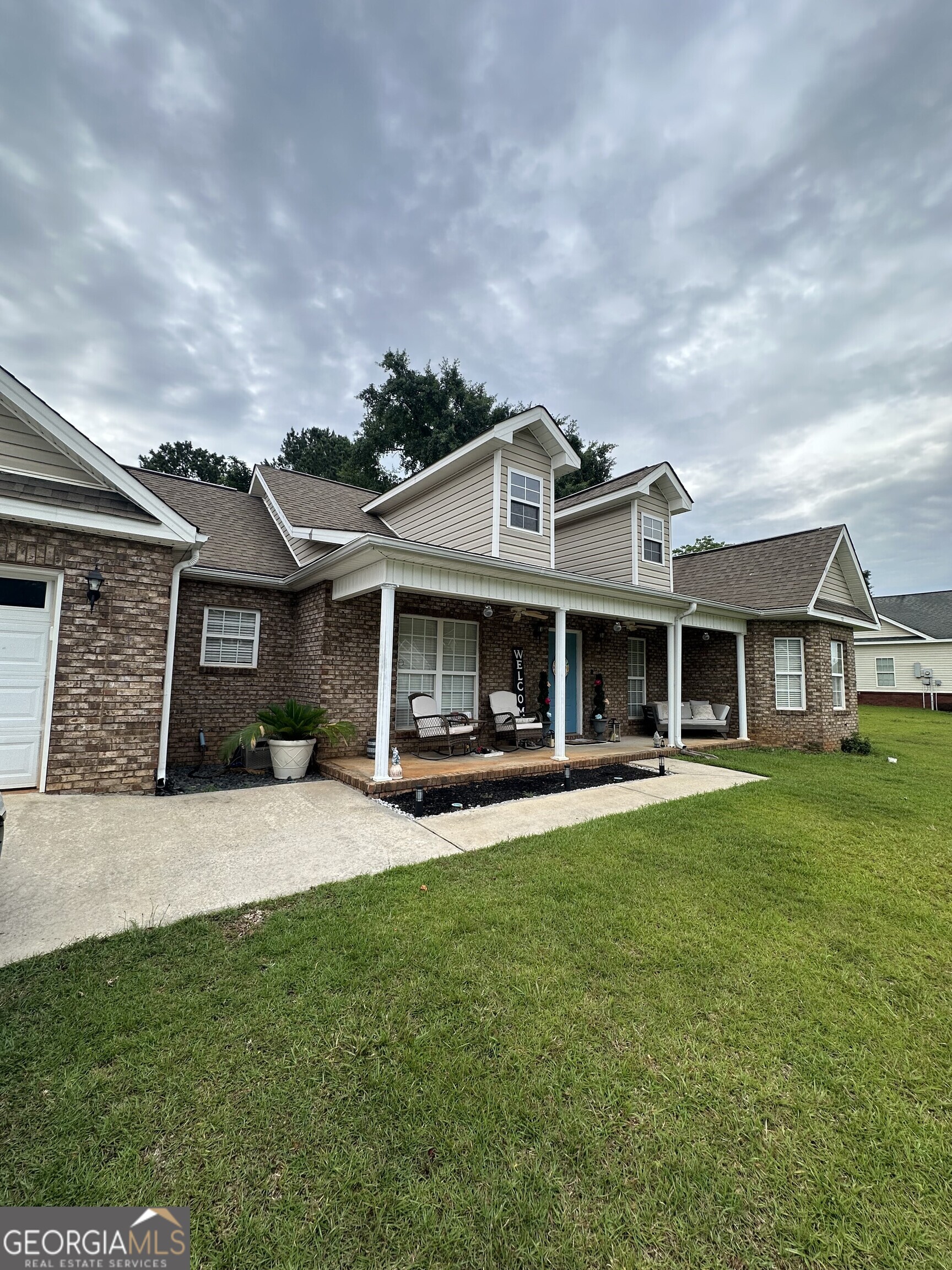 108 Christine Circle Perry, GA 31069 - Photo 2 of 23 a front view of a house with a garden