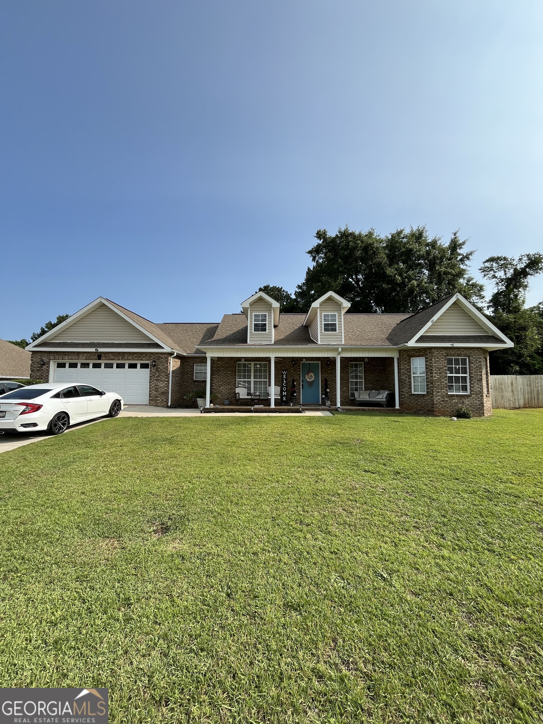 108 Christine Circle Perry, GA 31069 - Photo 3 of 23 a front view of a house with a garden