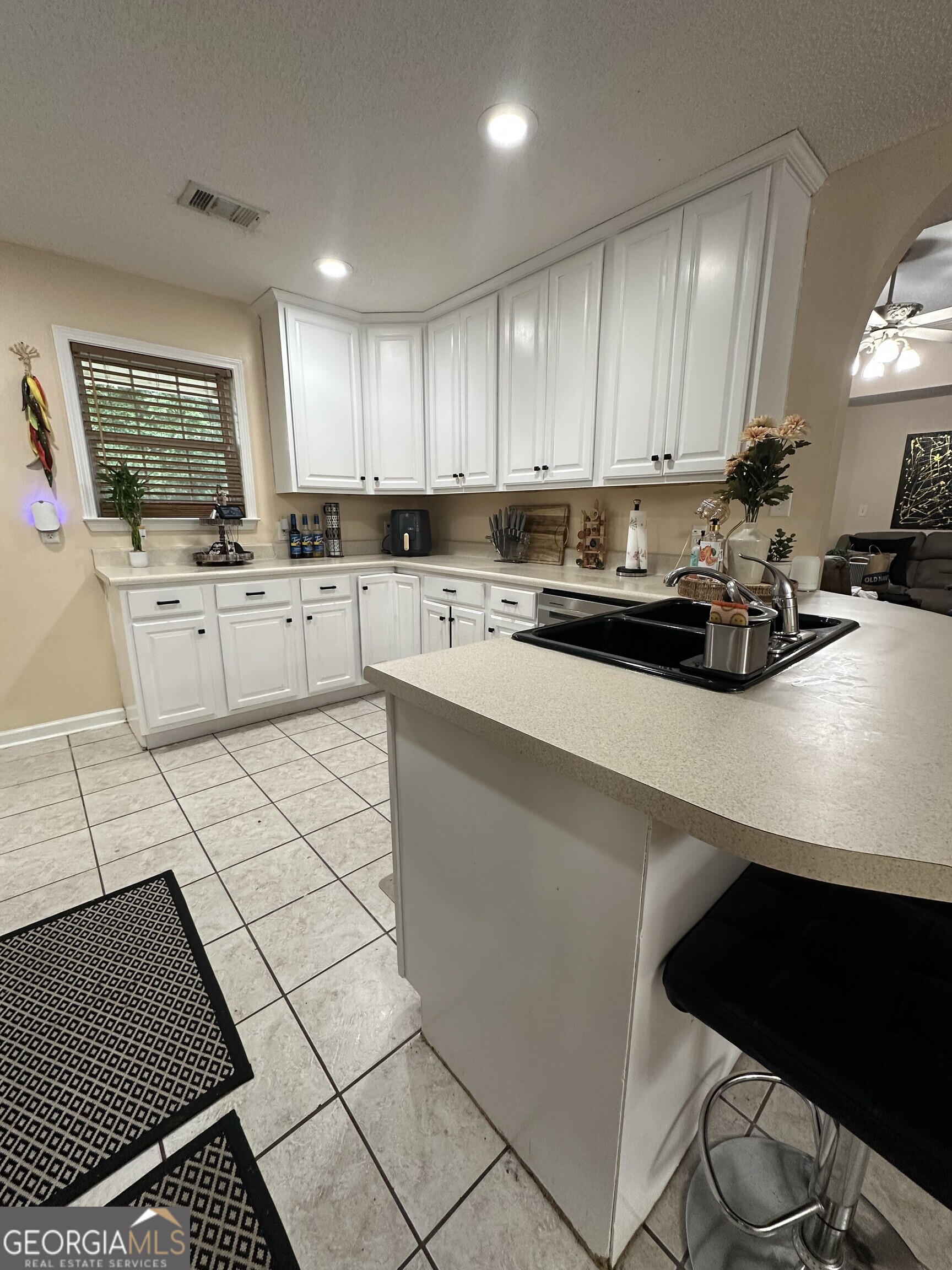 108 Christine Circle Perry, GA 31069 - Photo 6 of 23 a kitchen with a sink a stove cabinets and a window