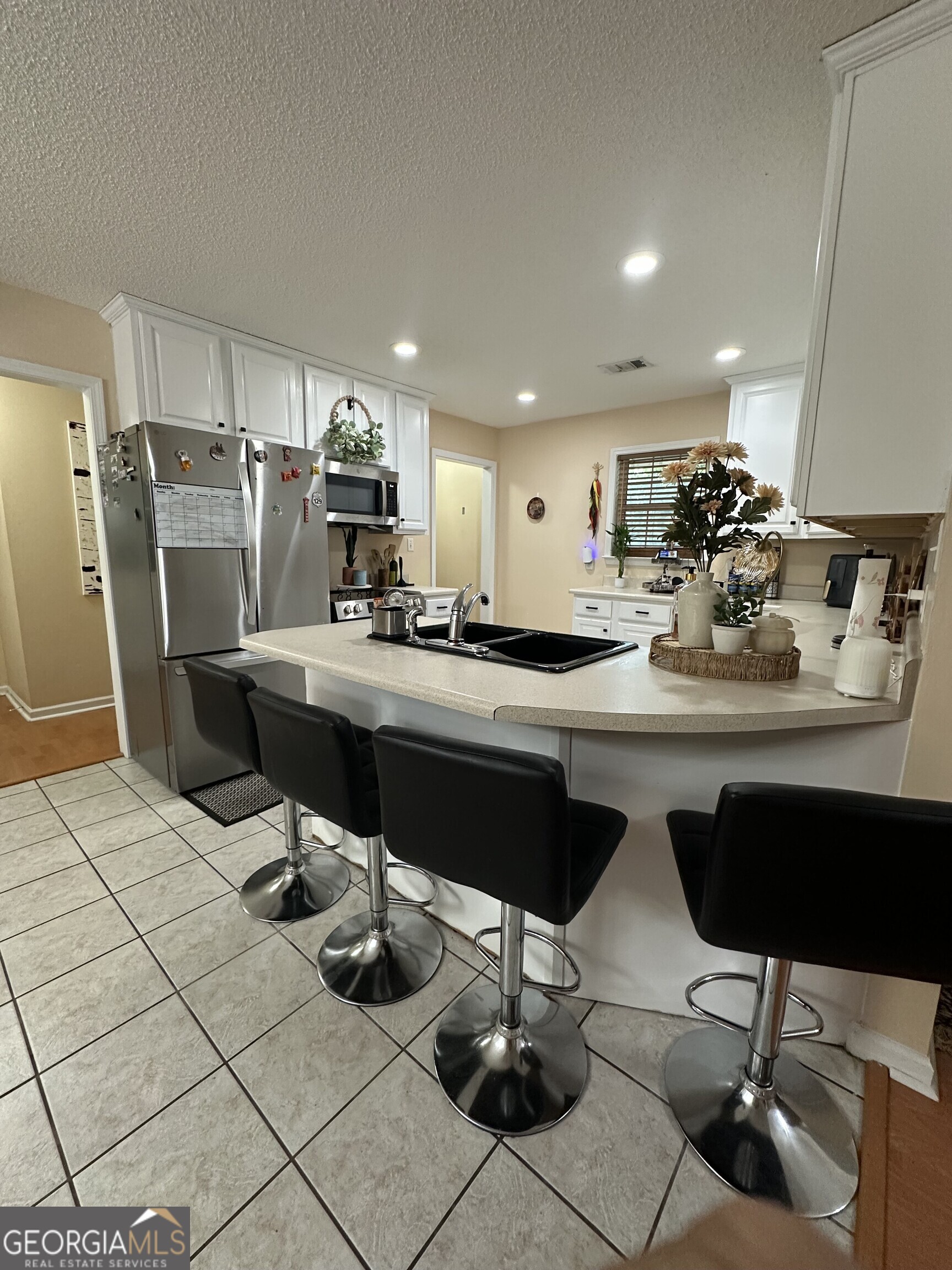 108 Christine Circle Perry, GA 31069 - Photo 7 of 23 a kitchen with a sink and chairs