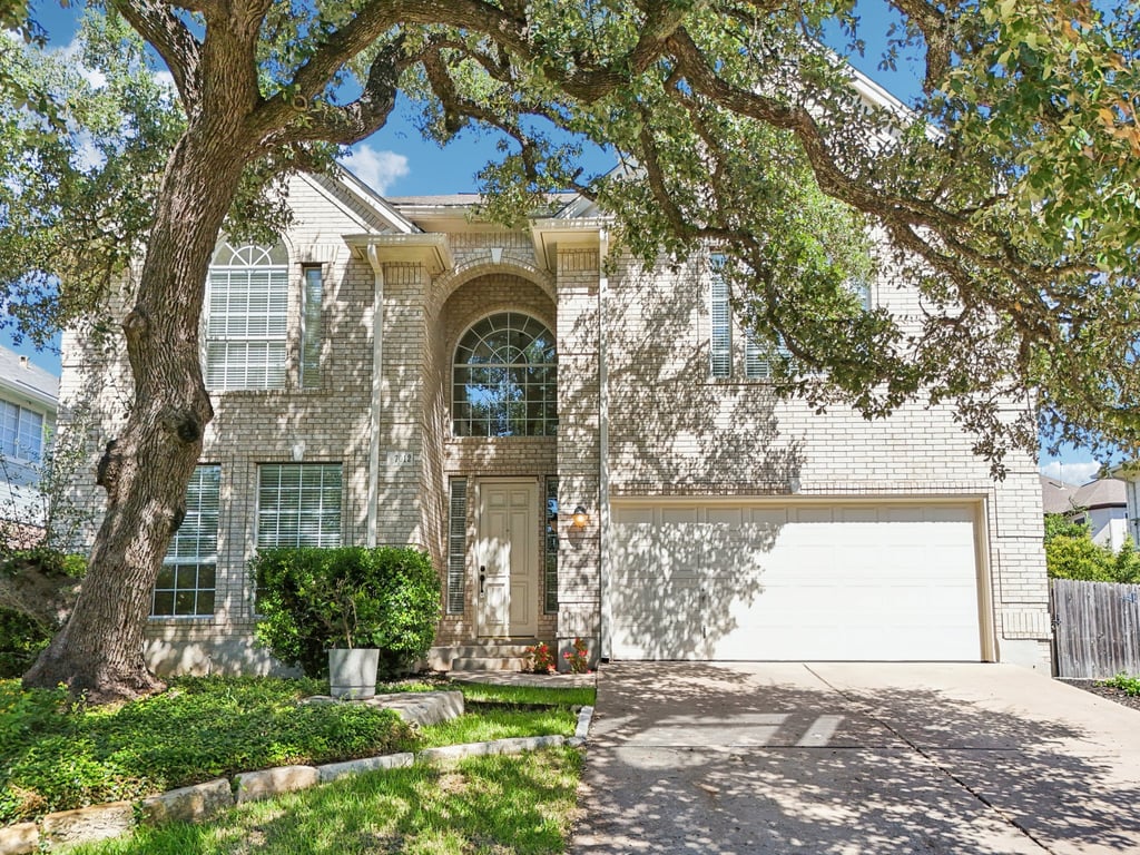 a front view of a house with a garden