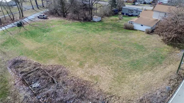 a view of a backyard with plants and outdoor seating