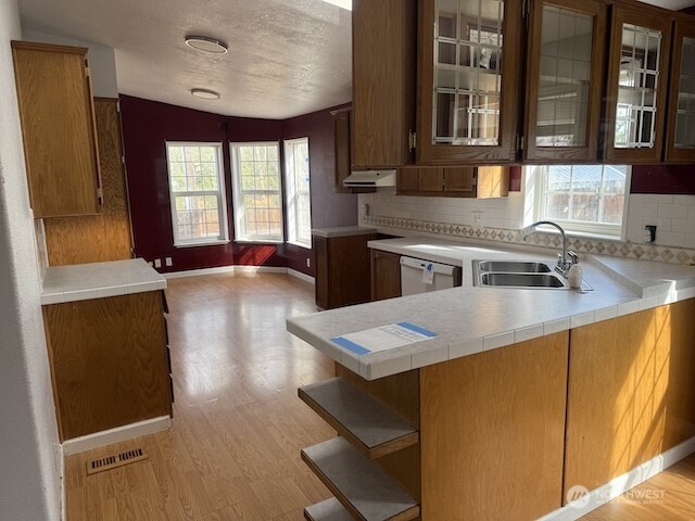 411 Sheets Road Yakima, WA 98901 - Photo 6 of 28 a kitchen with a sink a stove and black cabinets