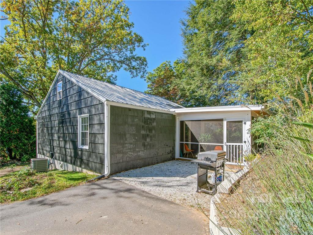 34 Canterbury Road Asheville, NC 28805 - Photo 2 of 3 a view of backyard with small cabin and wooden fence