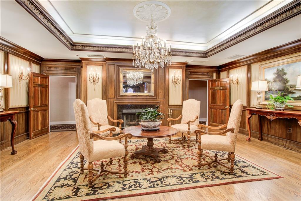 2865 Lenox Road Northeast, Unit 102 Atlanta, GA 30324 - Photo 34 of 35 a living room with fireplace furniture and a chandelier