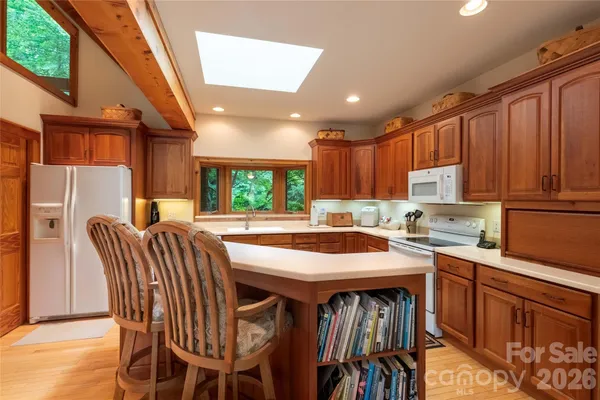 a bedroom with a bed a flat screen tv and a window