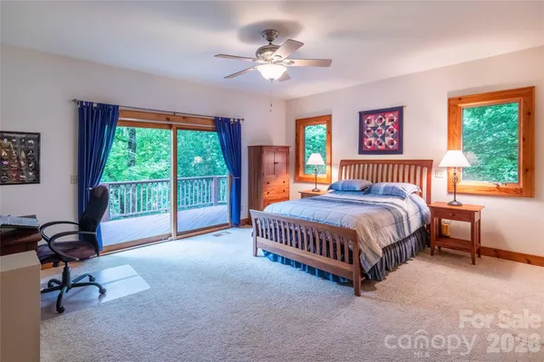 a bedroom with a bed next to a window