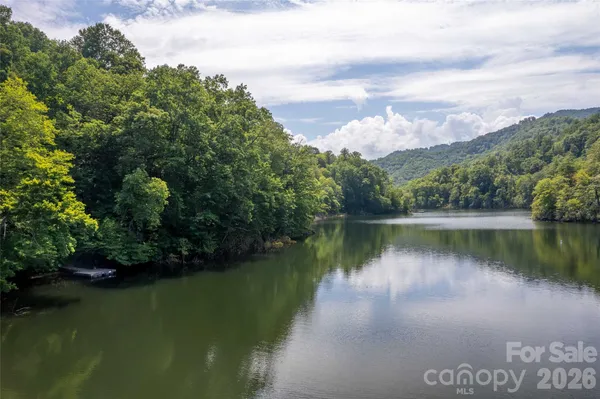 a view of a dining room with furniture large windows and wooden floor