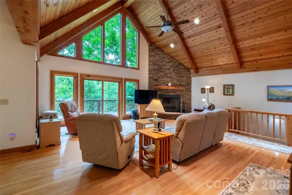 a kitchen with stainless steel appliances granite countertop a table chairs sink refrigerator and cabinets