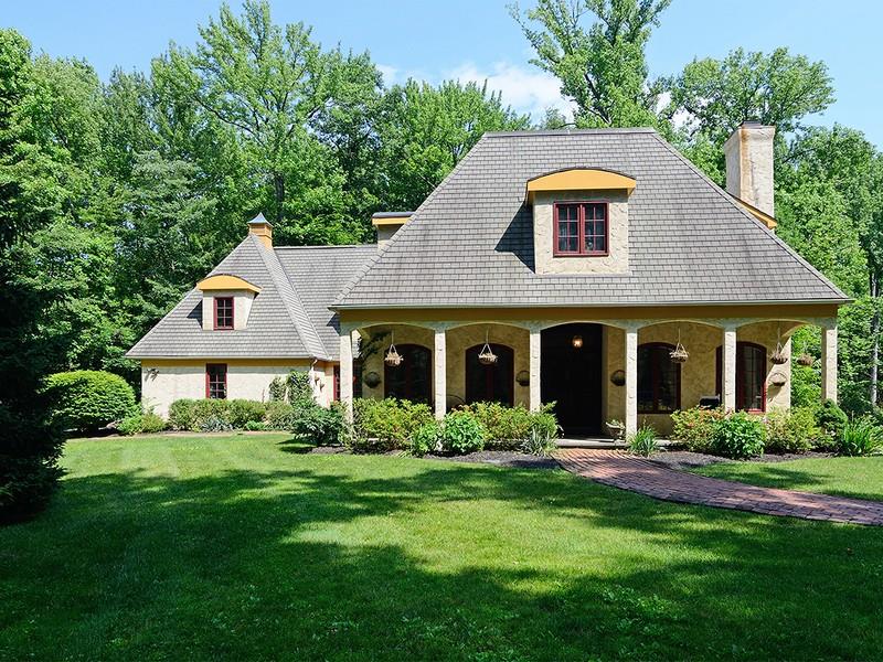 a front view of a house with porch and garden