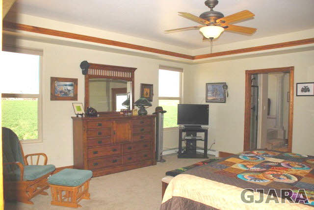 1682 14 Road Loma, CO 81524 - Photo 14 of 27 a bedroom with a bed and a chandelier