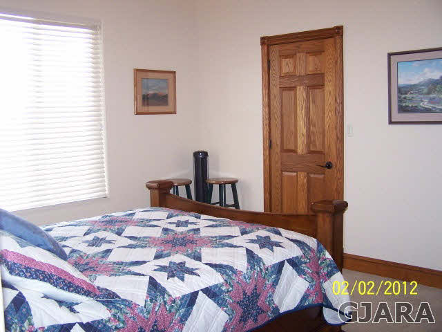 1682 14 Road Loma, CO 81524 - Photo 18 of 27 a bedroom with a bed and a window