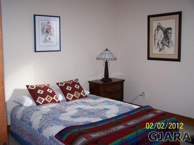 1682 14 Road Loma, CO 81524 - Photo 19 of 27 a bedroom with a bed and a painting on the wall
