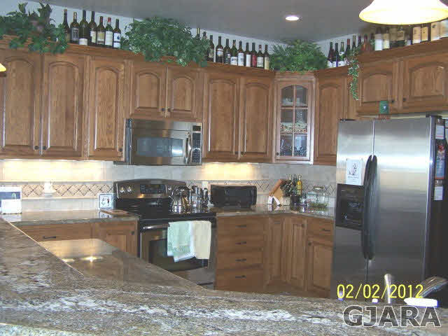 1682 14 Road Loma, CO 81524 - Photo 5 of 27 a kitchen with granite countertop a stove and cabinets