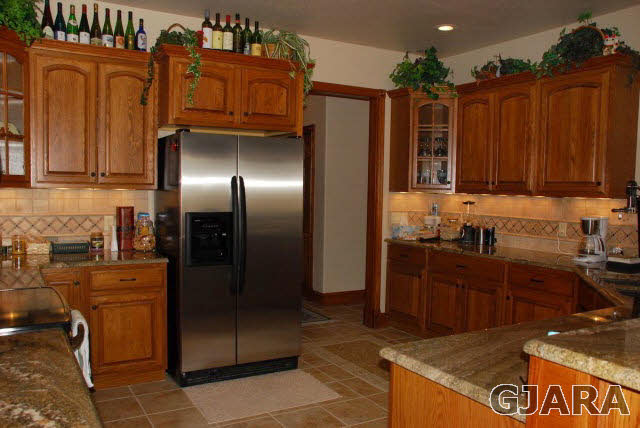 1682 14 Road Loma, CO 81524 - Photo 6 of 27 a kitchen with granite countertop a refrigerator stove and cabinets