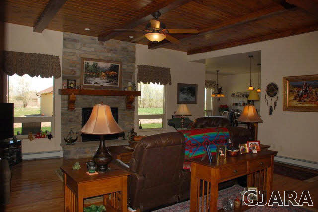 1682 14 Road Loma, CO 81524 - Photo 10 of 27 a living room with furniture a desk and chair with wooden floor
