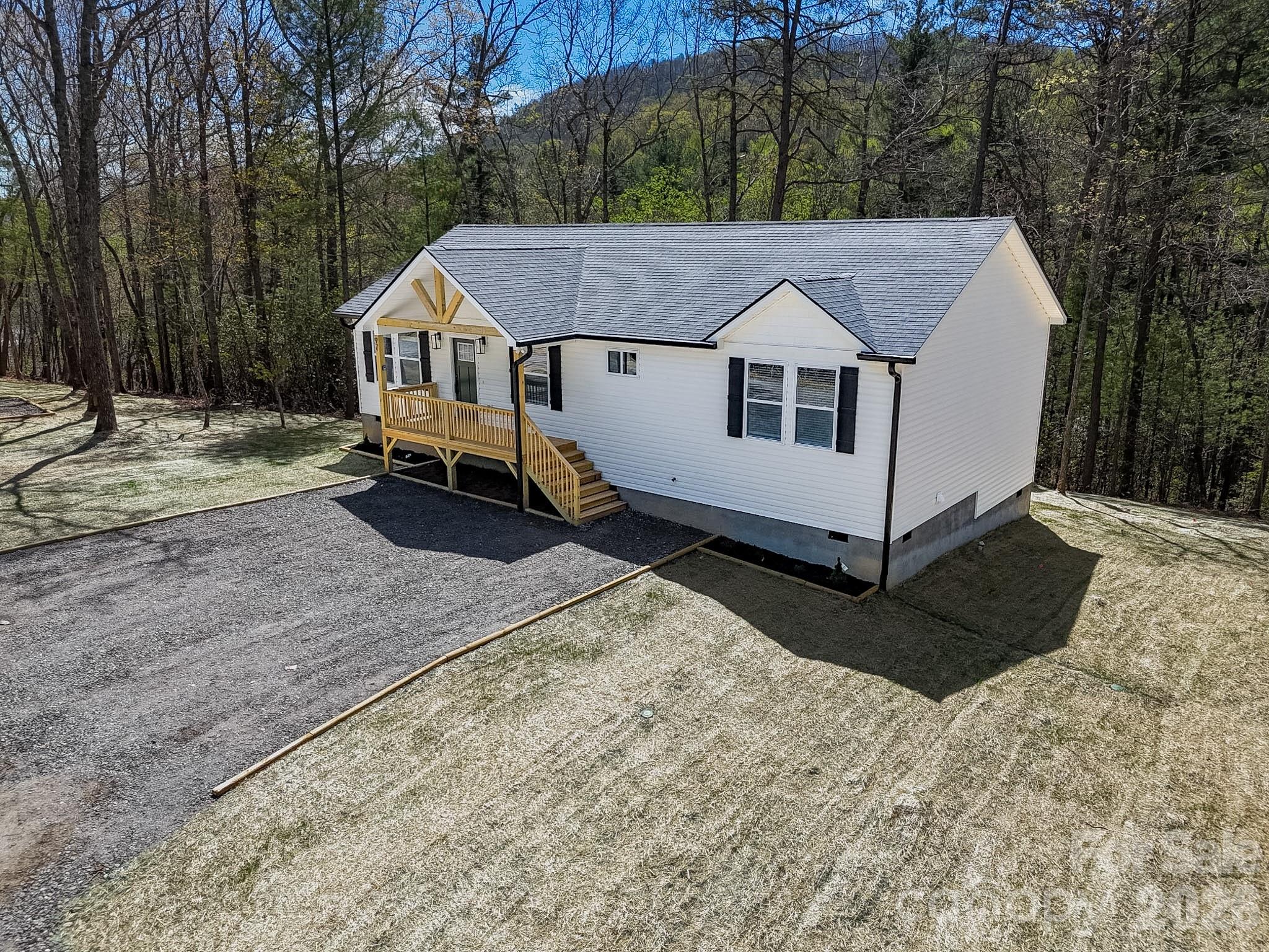 97 Lee Dotson Road Fairview, NC 28730 - Photo 2 of 45 a front view of a house with a yard covered in snow