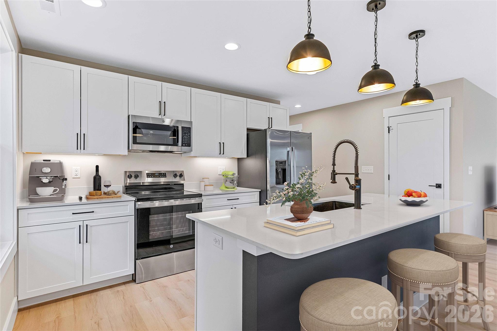 97 Lee Dotson Road Fairview, NC 28730 - Photo 21 of 45 a kitchen with stainless steel appliances a sink a stove a refrigerator and cabinets