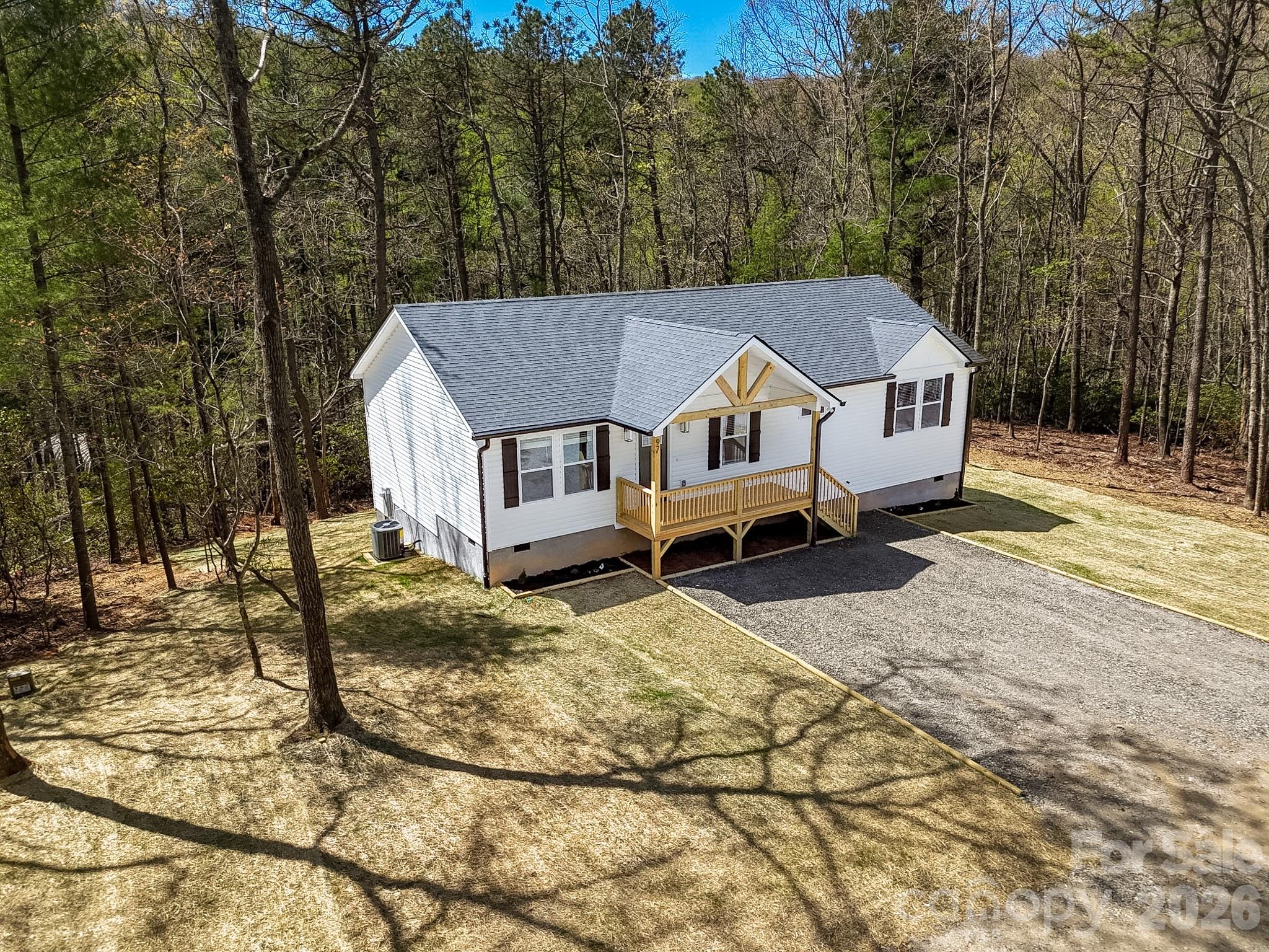 97 Lee Dotson Road Fairview, NC 28730 - Photo 4 of 45 a view of a house with a yard covered in snow