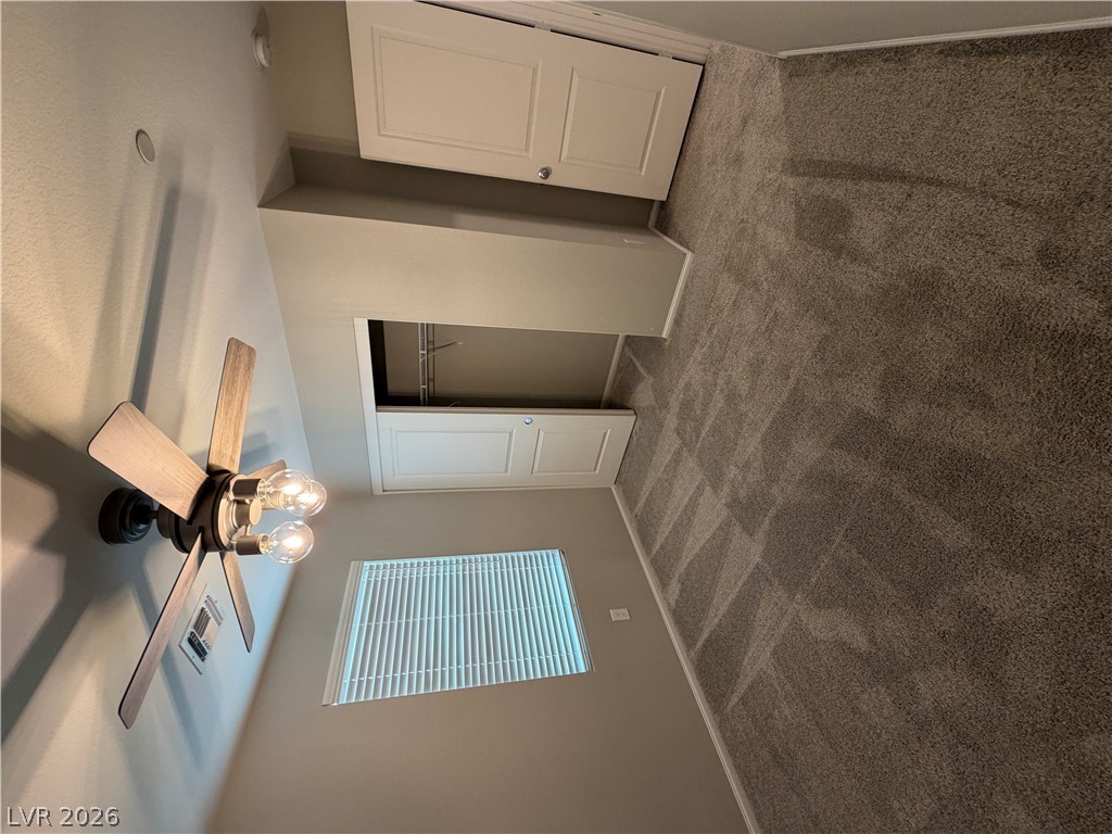 916 Riggs Flats Avenue North Las Vegas, NV 89086 - Photo 31 of 43 Plush carpeting anchors this bedroom containing integrated closet space and natural light.