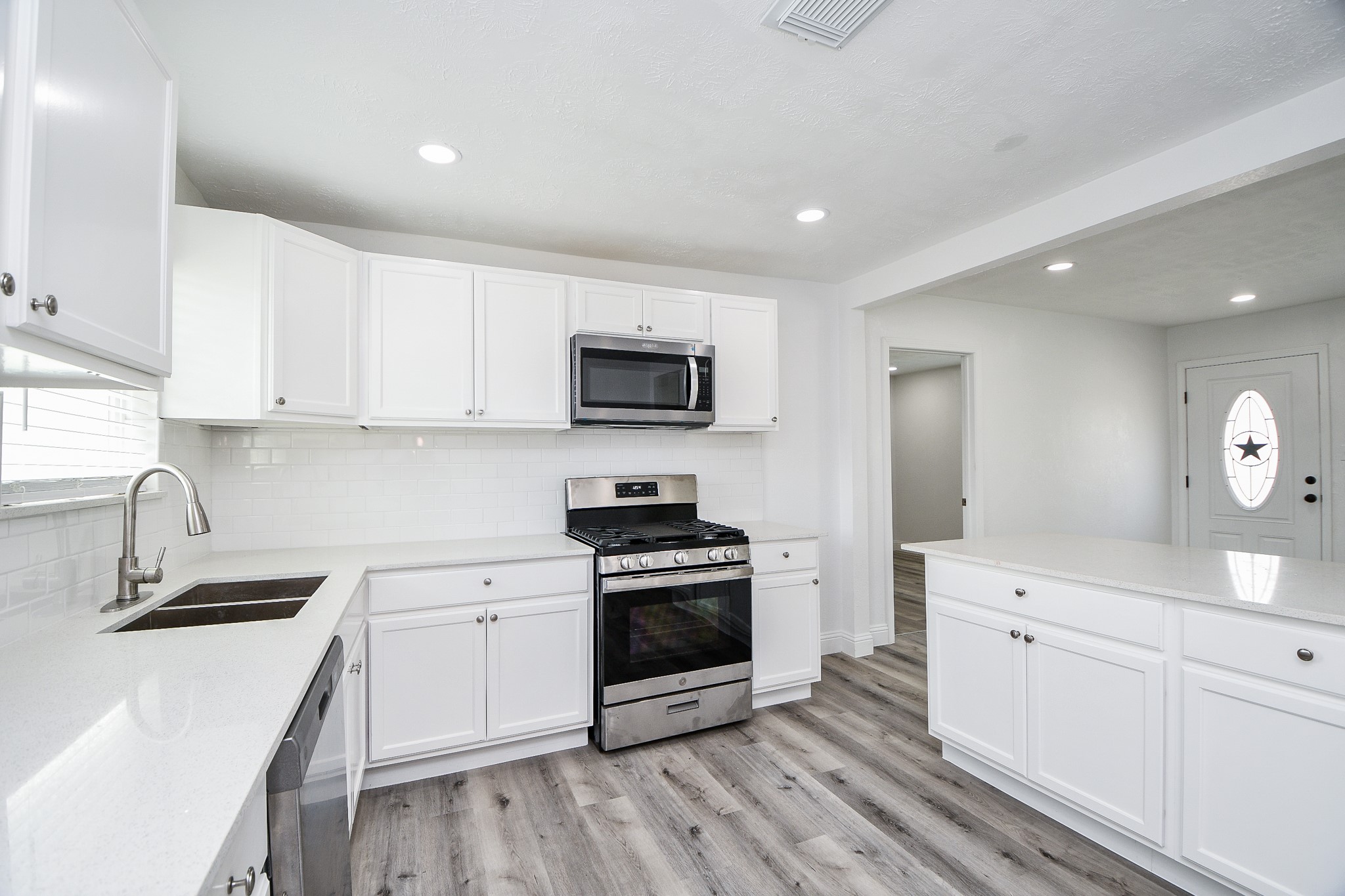 5814 Belneath Street Houston, TX 77033 - Photo 15 of 32 a kitchen with a sink stove and microwave