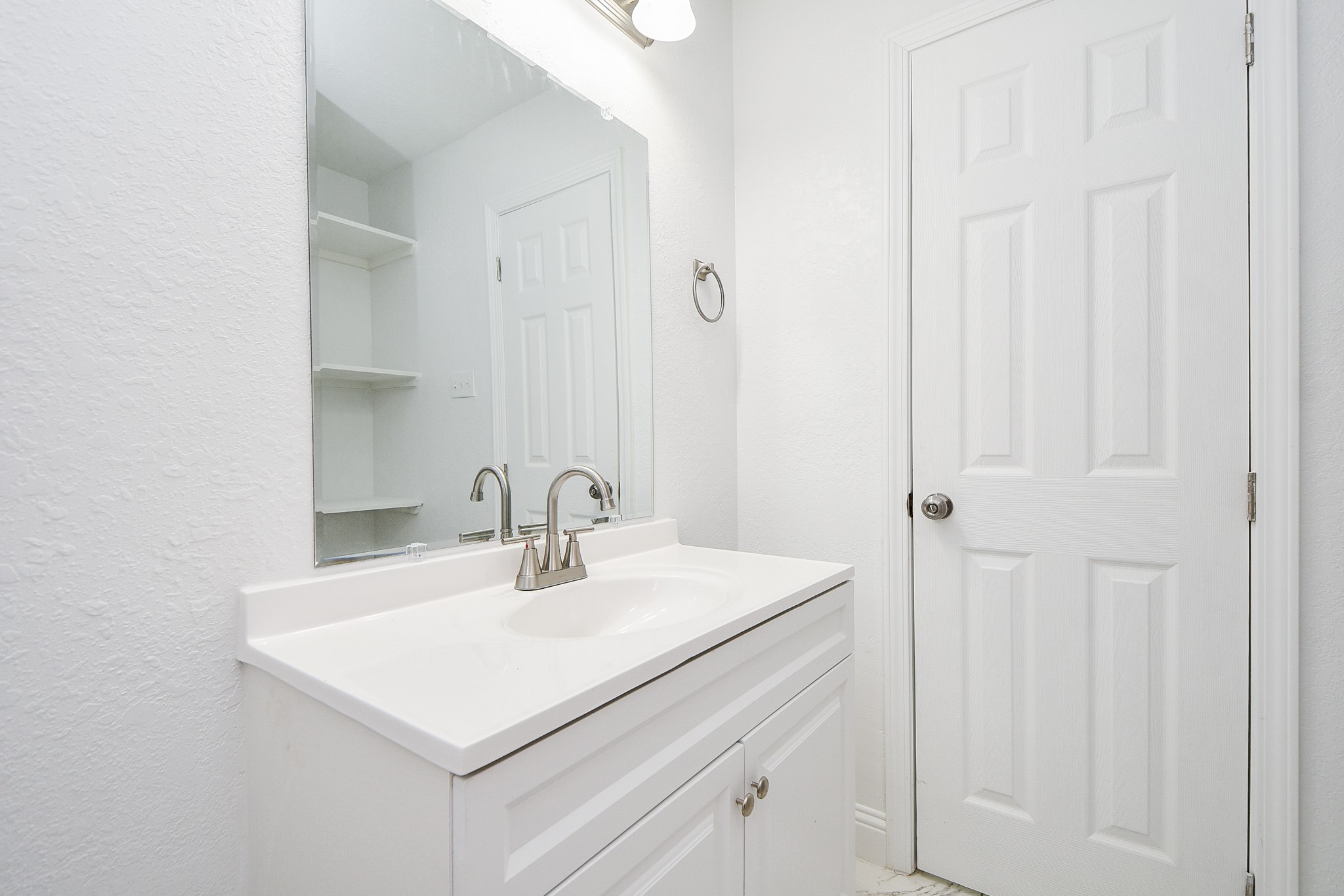 5814 Belneath Street Houston, TX 77033 - Photo 20 of 32 a bathroom with a sink and a mirror