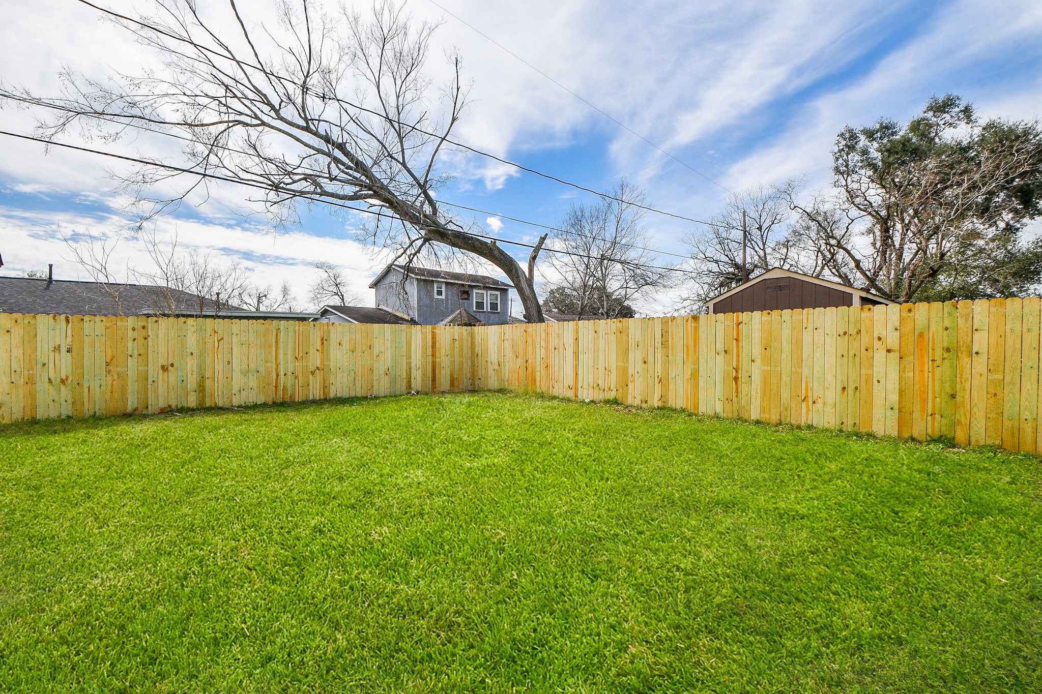 5814 Belneath Street Houston, TX 77033 - Photo 27 of 32 a view of a backyard with wooden fence