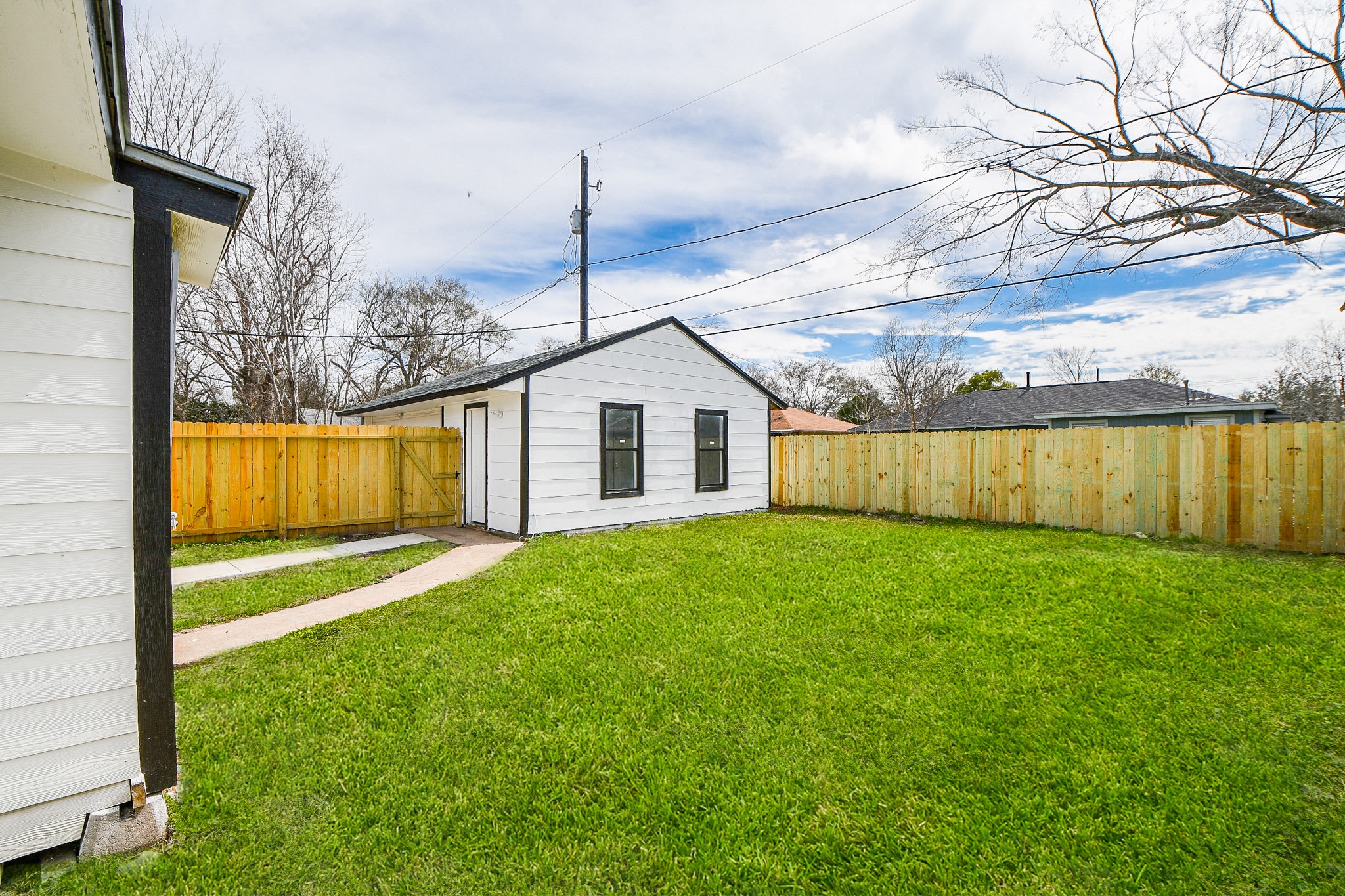 5814 Belneath Street Houston, TX 77033 - Photo 28 of 32 a view of a backyard with table and chairs and wooden fence