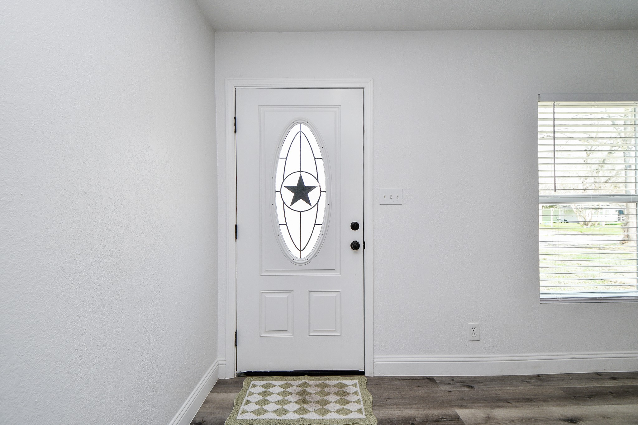 5814 Belneath Street Houston, TX 77033 - Photo 7 of 32 a view of a entryway door with wooden floor