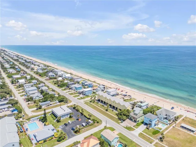 an aerial view of residential building and ocean view