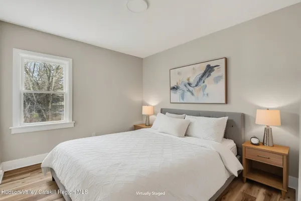 a bedroom with a large bed and a window