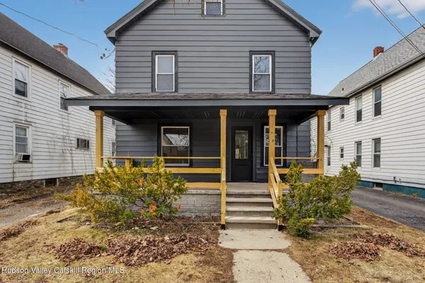 a view of a house with wooden fence