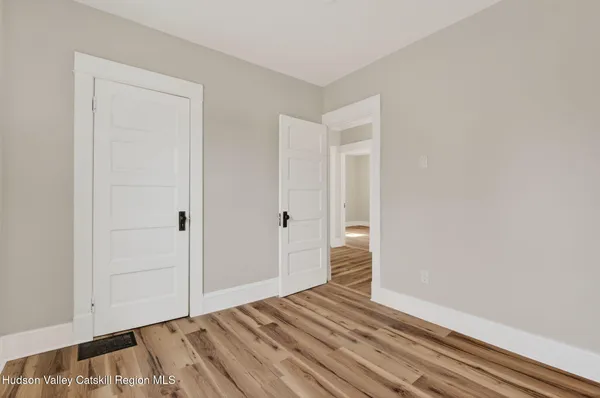 a view of a room with wooden floor and closet