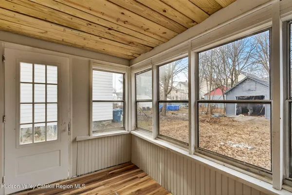 a view of a room with wooden floor and windows
