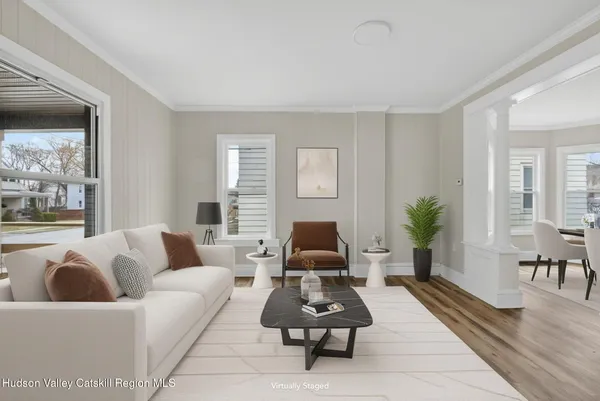 a living room with furniture rug and window