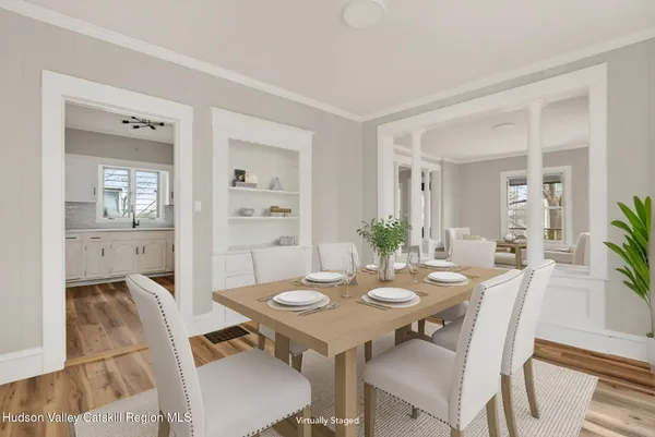 a view of a dining room with furniture and wooden floor