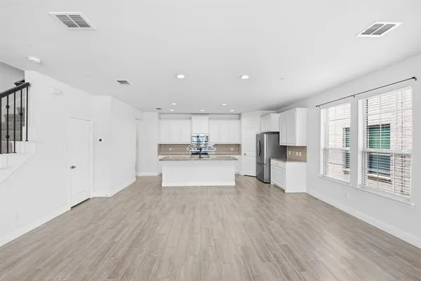 a view of large kitchen with wooden floor