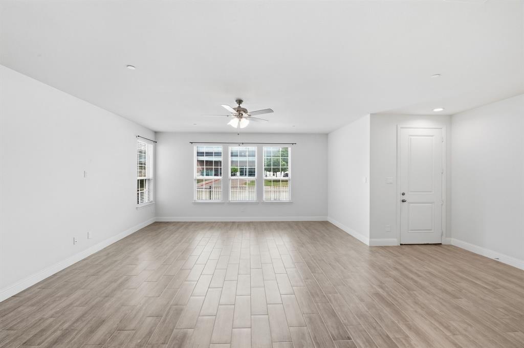 5960 Bursey Road Watauga, TX 76148 - Photo 12 of 38 an empty room with wooden floor and windows
